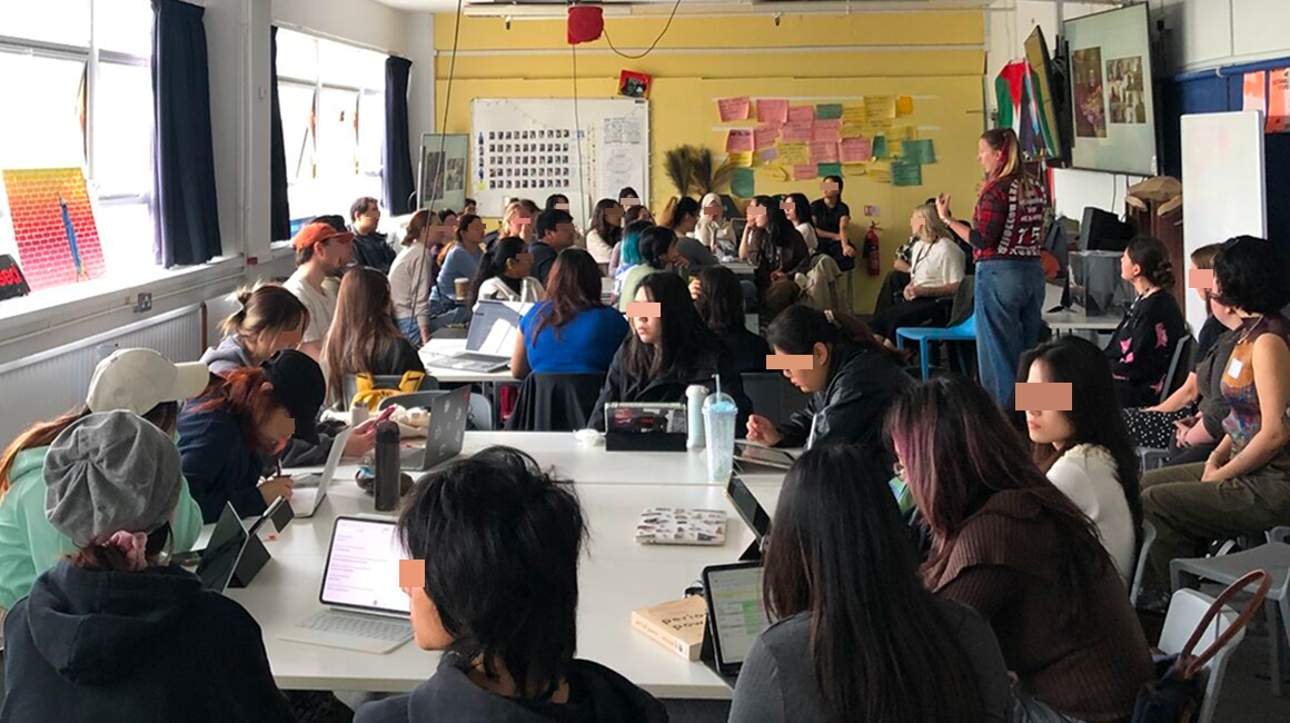 Chiara is giving a lecture in front of a postgraduate class of around 50 people.