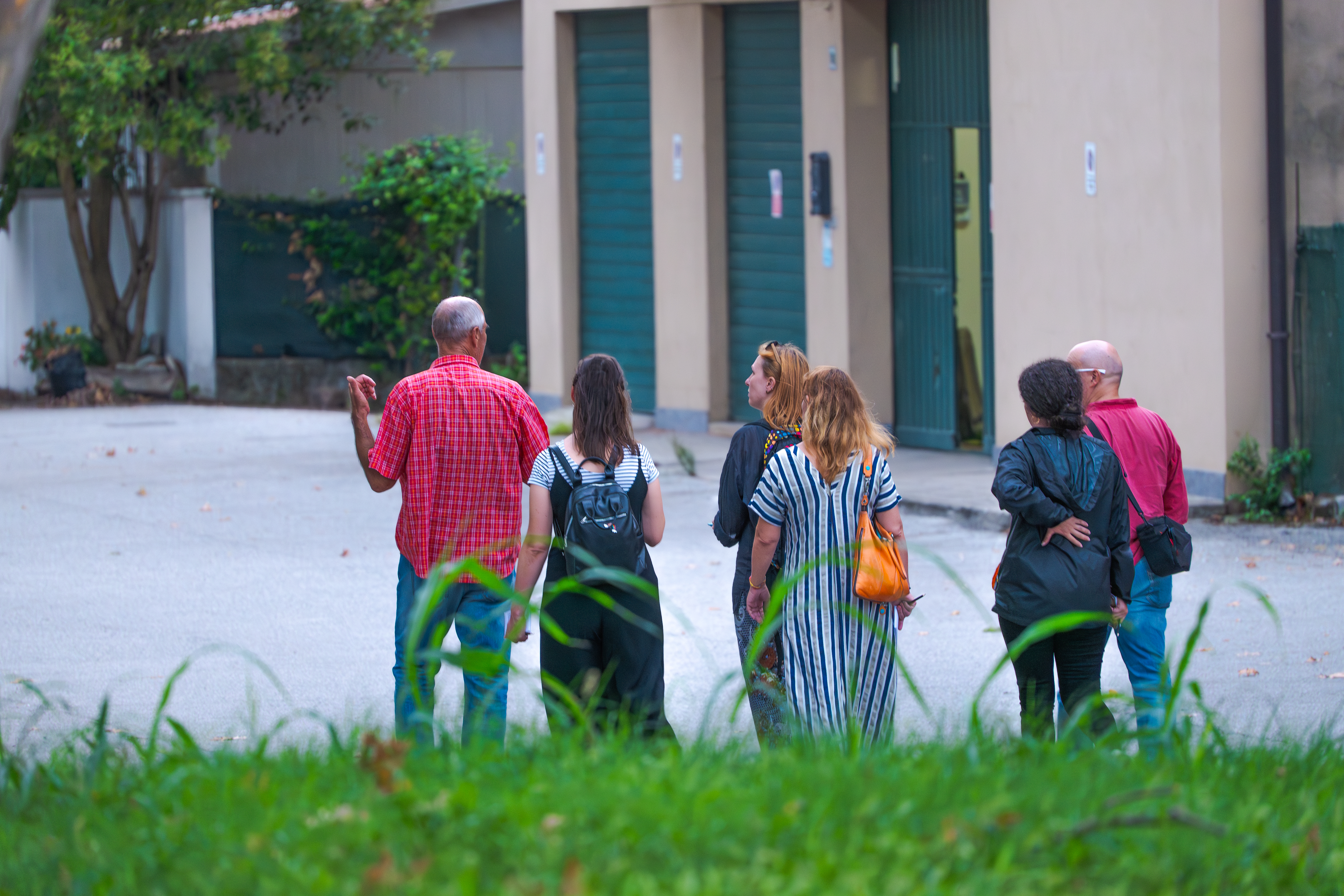 A group of people walk in Marghera talking to each other