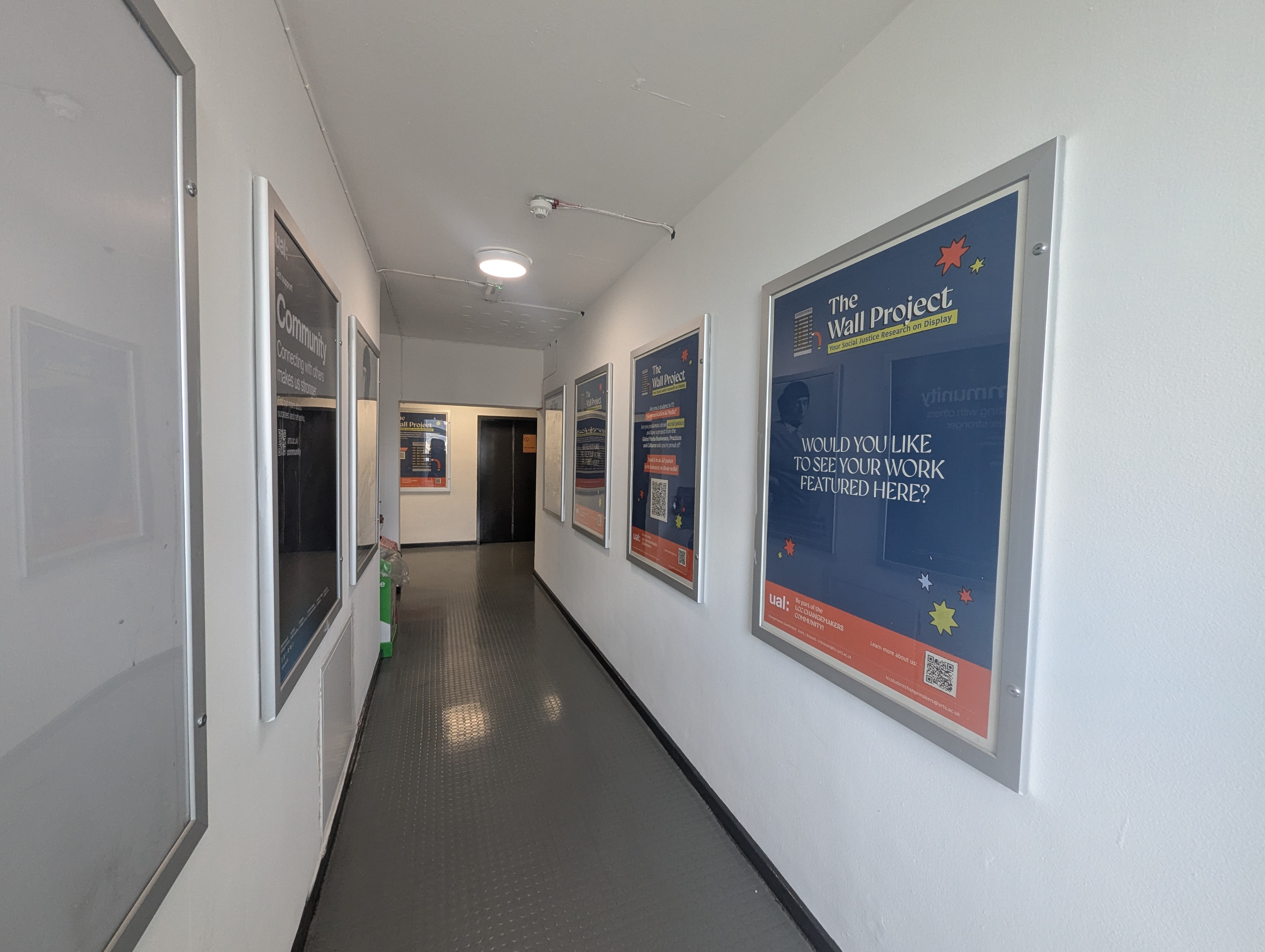 7th-floor corridor of LCC Tower Block with call-to-action's posters of the Wall Project.